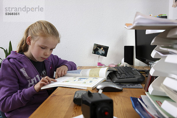 Mädchen  10 Jahre  macht in ihrem Kinderzimmer Hausaufgaben  lernt für die Schule