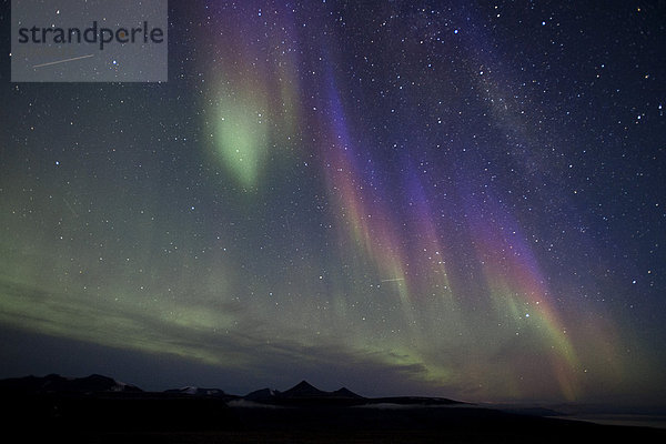 Grüne  blaue und violette Nordlichter  sowie die Spuren von zwei Satelliten  Spitzbergen  Norwegen  Skandinavien  Europa