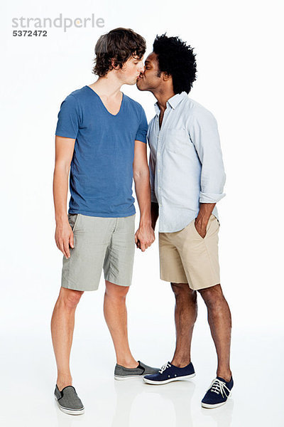 Gay Couple kissing against white background