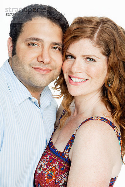 Couple smiling against white background