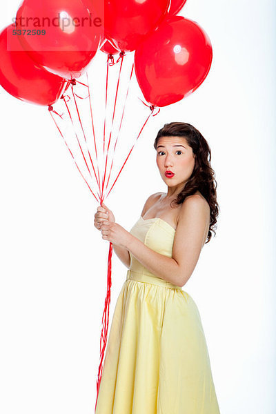 Young Woman holding Ballons against white background