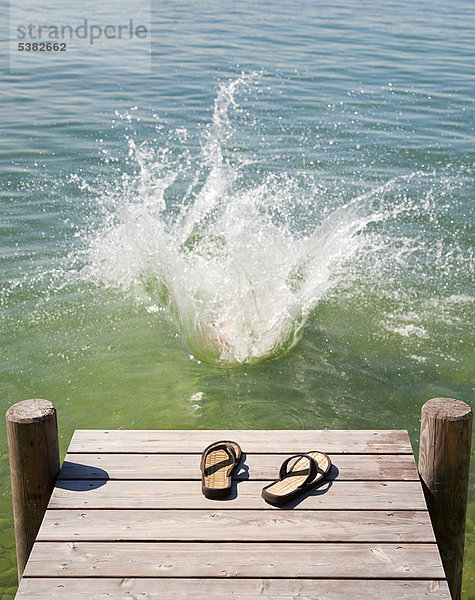 Flip Flops auf Holzdeck am See