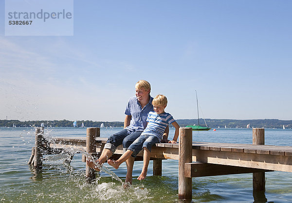 Vater und Sohn baumeln im See