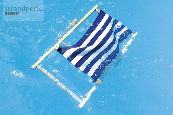 Deckchair in a pool  symbolic for a disasterous holiday