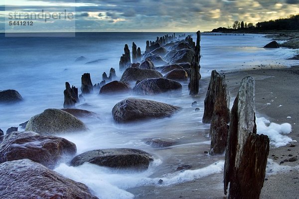 Stones and stakes at a seashore