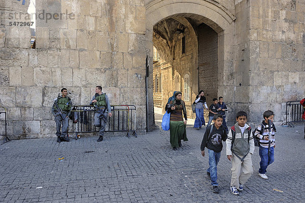 Israelische Wachsoldaten und palästinensische Kinder mit Spielzeuggewehren  die aus dem Arabischen Viertel durch das Löwentor vor der Altstadt von Jerusalem herauskommen  Israel  Vorderasien