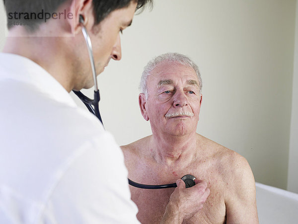 Deutschland  Hamburg  Arzt untersucht Patient mit Stethoskop in der Klinik
