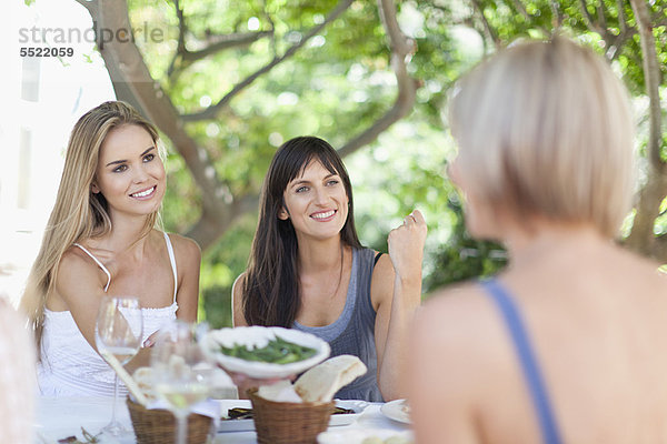 Frauen beim Essen am Tisch im Freien