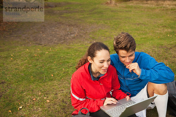 Junges Paar mit Laptop im park