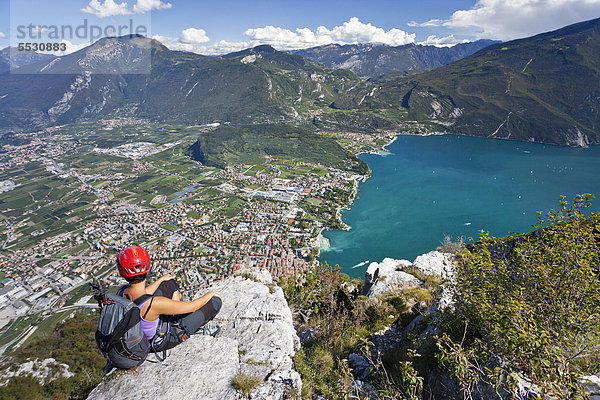 Kletterin am Klettersteig Via dell Amicizia  mit Blick auf Gardasee und Riva  Trentino  Italien  Europa