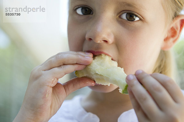 Kleines Mädchen isst Apfel