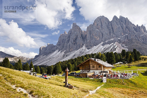 Wanderer bei der Geisleralm im Villnösstal unterhalb der Geislerspitzen  hinten die Geislergruppe  Sass Rigais  Dolomiten  Südtirol  Italien  Europa