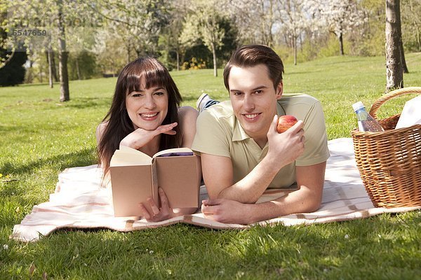 Junges Paar macht ein Picknick auf einer Wiese
