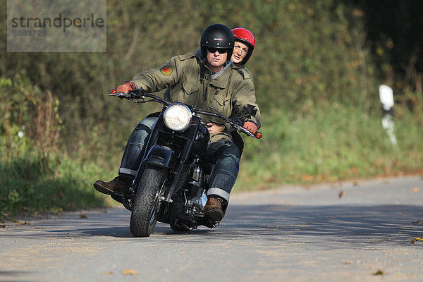 Paar fährt Motorrad auf einer Landstraße