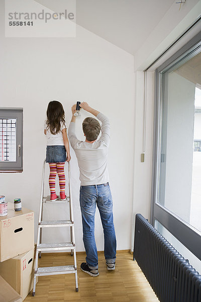 Vater und Tochter arbeiten im neuen Haus