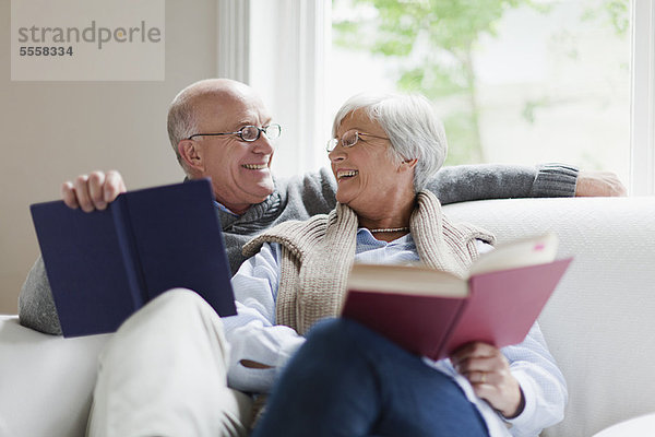 Lächelndes älteres Paar beim Lesen von Büchern