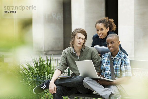 Studenten auf dem Campus mit Laptop