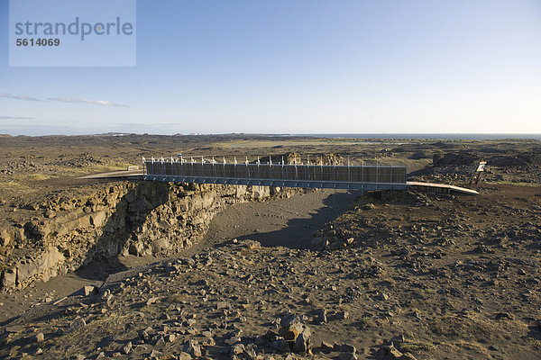 Eine Brücke führt übder den Grabenbruch zwischen der amerikanischen  vorne  und der europäischen Kontinentalplatte  Halbinsel Reykjanes  Island  Nordeuropa  Europa