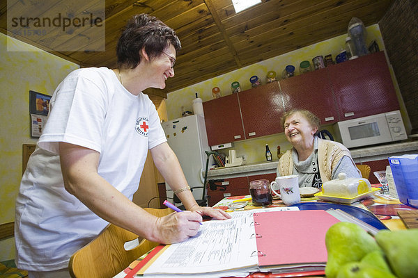 Ambulante Pflege des Deutschen Roten Kreuzes  Pflegeschwester Anke Lehmann bereitet das Frühstück für eine Herzinfarktpatientin  Treuenbrietzen  Brandenburg  Deutschland  Europa