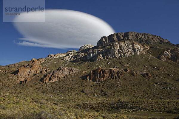 Chilenische Anden bei Cochrane im Abendlicht unter einer großen weißen Kumulus-Wolke  Altocumulus lenticularis  Rio Chacabuco  Cochrane  Region de Aysen  Patagonien  Chile  Südamerika  Amerika