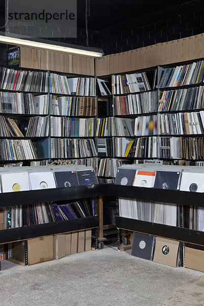Reihen von Schallplatten in Regalen und Behältern eines Plattenladens
