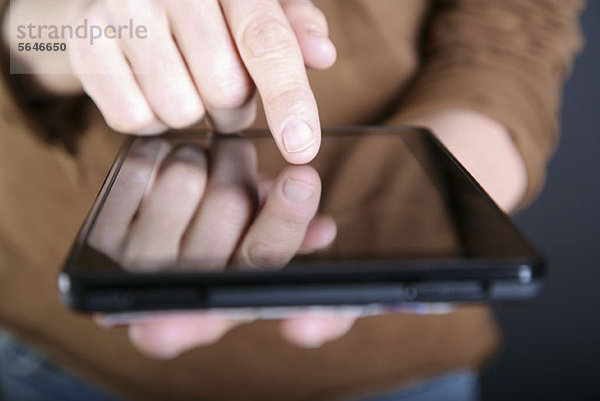 Ein Mann  der ein digitales Tablett benutzt  Nahaufnahme der Hand.