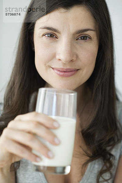 Mittlere erwachsene Frau mit Milchglas