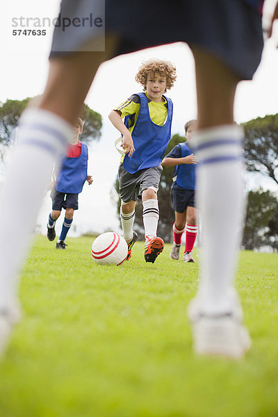 Jungen spielen Fußball auf dem Spielfeld