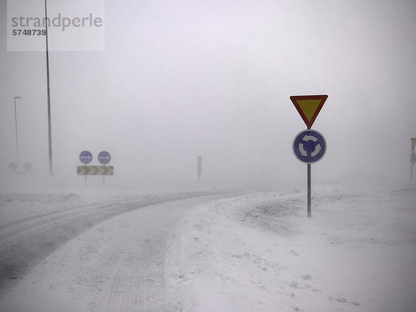 Straßenschilder in verschneiter Landschaft