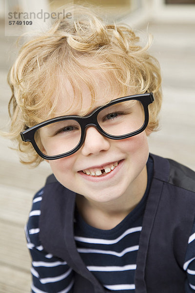 Lächelnder Junge mit Brille im Freien
