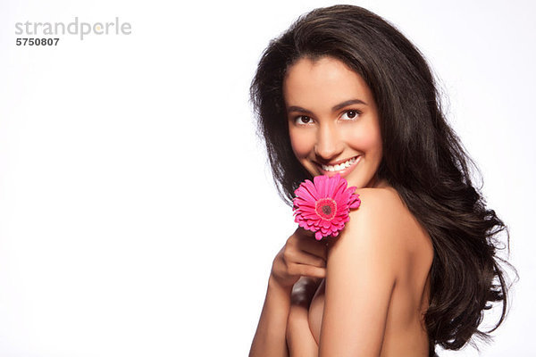 Young Woman holding pink Flower against white background