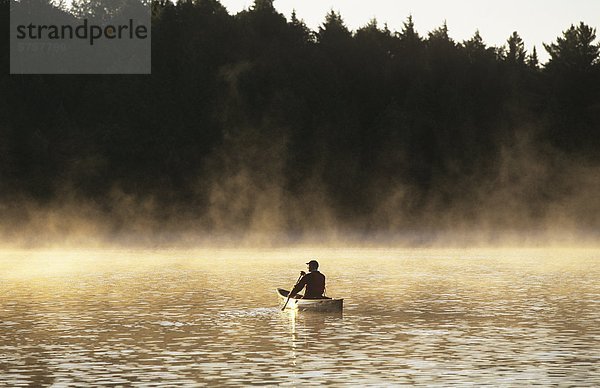 Mann mittleren Alters Kanu auf Rauch See  Algonquin Provincial Park  Ontario  Kanada.