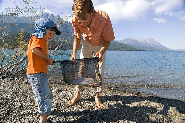 Menschlicher Vater Sohn Reise fangen Netz angeln Forelle