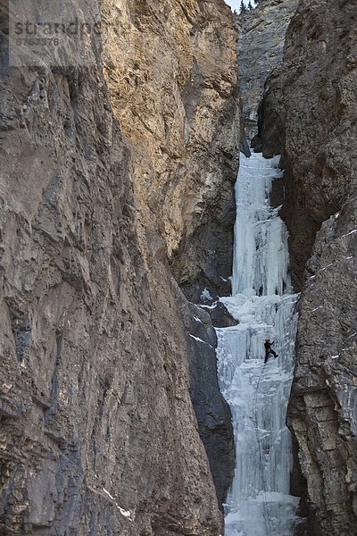 Ein Mann mittleren Alter Climbc Aquarius WI4  in der schönen Ghost River Valley in Alberta  Kanada