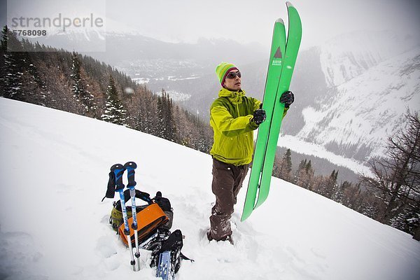 Ein Hinterland Snowboarder zusammenstellt seine Splitboard für die Fahrt nach unten  Tryst See  Kananaskis  Alberta  Kanada