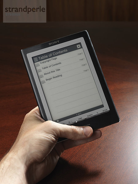Person holding Touchchscreen e-book device  Sony PRS-700 reader