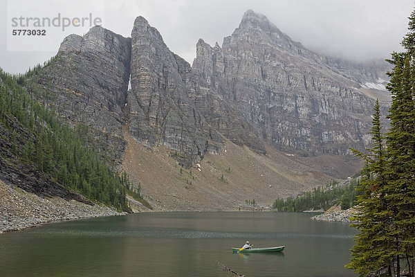 Mann Kanu am Lake Agnes an einem regnerischen Tag in Banff Nationalpark  Alberta  Kanada