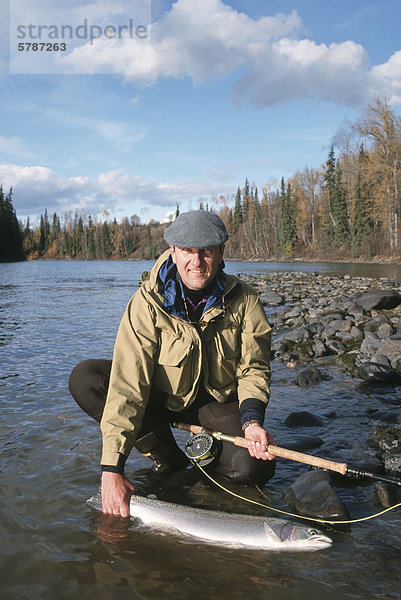 Angler with steelhead  Bulkley river  British Columbia  Canada.