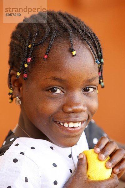 Afrikanische Mädchen essen ein Orange  Lome  Togo  Westafrika  Afrika