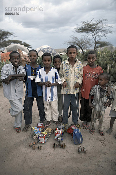Kinder mit hausgemachten Spielzeug posieren für ein Foto in einem Camp intern Vertriebene in die Stadt von Hargeisa  Hauptstadt von Somaliland  Somalia  Afrika