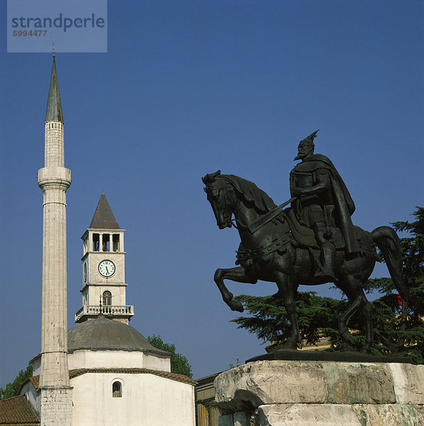Die Statue des Skanderberg mit der Turmuhr und Minarett der Moschee jenseits in Tirana  Albanien  Europa
