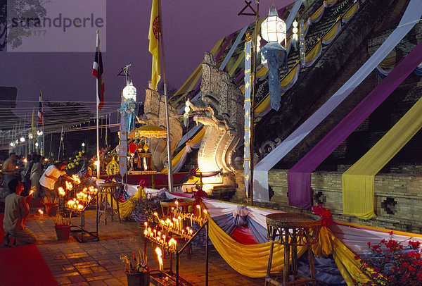 Menschen anbeten während buddhistischen Festivals am Fuße des Tempels Chedi  Wat Chedi Luang  Chiang Mai  Thailand  Südostasien  Asien