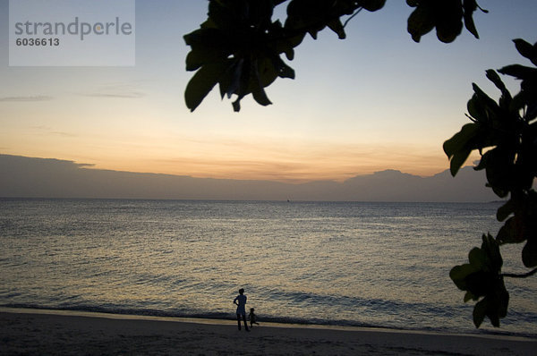 Menschen Wandern am Strand bei Sonnenuntergang  Stone Town  Sansibar  Tansania  Ostafrika  Afrika