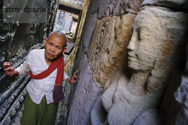 Eine buddhistische Nonne macht ihren Weg durch Preah Khan Tempel  Angkor  UNESCO Weltkulturerbe  Kambodscha  Indochina  Südostasien  Asien