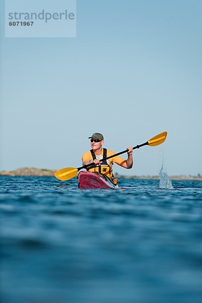 Man kayaking across sea  Sweden