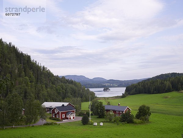 House with mountain  lake in background