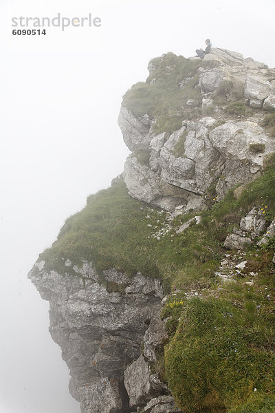 Germany  Bavaria  Person sitting on Nebelhorn Mountain