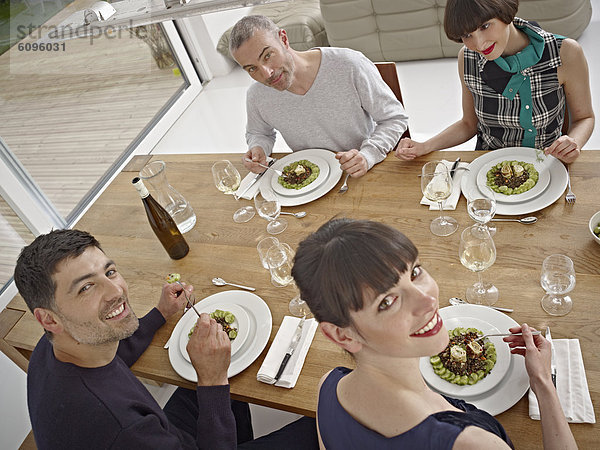 Men and women having dinner