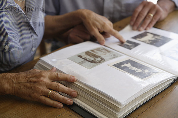 Germany  Bavaria  Senior couple with photo album