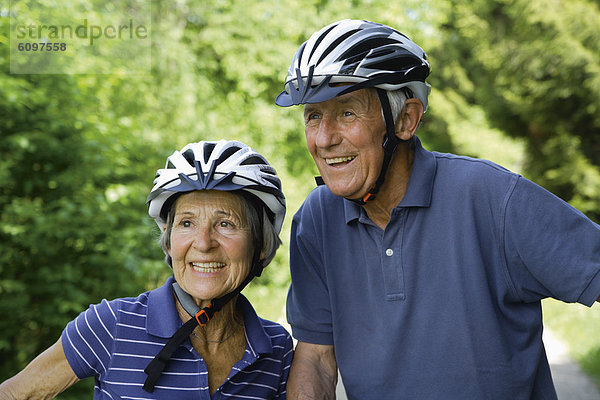 Germany  Bavaria  Senior couple with bicycle helmet  smiling